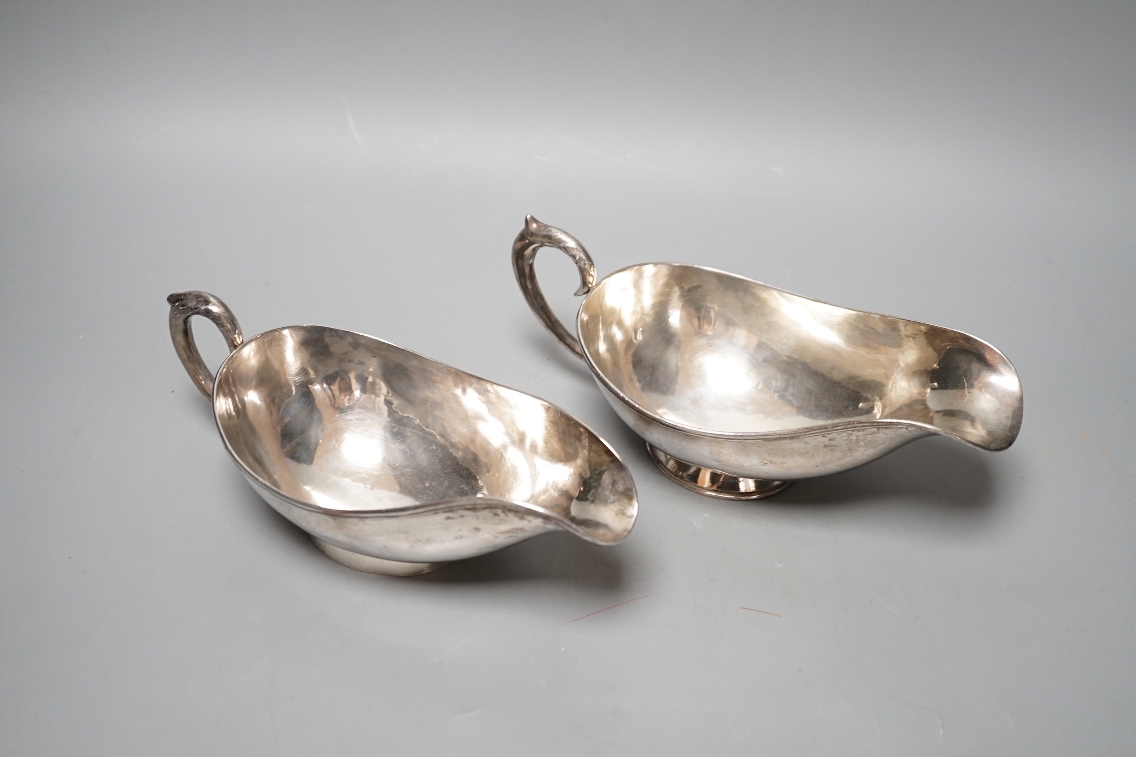 A pair of Chinese white metal sauce boats, by Yung Shun, 21.2cm, 11.5 grams.